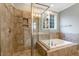 Elegant bathroom with a glass-enclosed shower, soaking tub, and tiled walls, creating a spa-like experience at 3650 Brooks Bnd, Franklinton, NC 27525