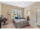 Bright bedroom featuring a decorative chandelier, a large window, and a view into the ensuite bath at 3650 Brooks Bnd, Franklinton, NC 27525