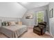 Bedroom featuring soft carpet, a window for natural light, and an accent wall and artwork at 3650 Brooks Bnd, Franklinton, NC 27525