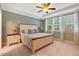 Bright bedroom with tray ceilings, a ceiling fan, large windows, and neutral tones for a serene retreat at 3650 Brooks Bnd, Franklinton, NC 27525