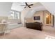 Bright bonus room featuring a ceiling fan, built-in seating, and a comfy leather sofa with a TV at 3650 Brooks Bnd, Franklinton, NC 27525