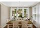 Bright dining area with large windows, hardwood floors, and stylish decor at 3650 Brooks Bnd, Franklinton, NC 27525