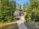 Charming two-story home surrounded by mature trees with a long driveway and two-car garage at 3650 Brooks Bnd, Franklinton, NC 27525