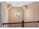 Upper hallway with an ornate hanging light fixture and a dark wood banister overlooking the home's entry at 3650 Brooks Bnd, Franklinton, NC 27525