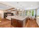 Open-concept kitchen with a large island, stainless steel appliances, and seamless connection to the living area at 3650 Brooks Bnd, Franklinton, NC 27525