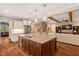 Expansive kitchen island featuring granite countertops, stainless steel appliances, and stylish pendant lighting at 3650 Brooks Bnd, Franklinton, NC 27525