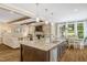 Spacious kitchen with granite countertops and an open view to the living room and dining area at 3650 Brooks Bnd, Franklinton, NC 27525