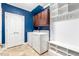 Well-organized laundry room features washer, dryer, storage cabinets, and built-in shelving for convenience at 3650 Brooks Bnd, Franklinton, NC 27525