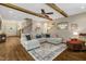 Comfortable living room with wood floors, a ceiling fan, a fireplace, and staircase to the second floor at 3650 Brooks Bnd, Franklinton, NC 27525