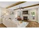 Bright living room features a stone fireplace, wood beams, and a ceiling fan at 3650 Brooks Bnd, Franklinton, NC 27525