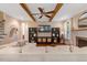 Cozy living room with exposed beams, a fireplace, and comfortable seating, perfect for relaxation at 3650 Brooks Bnd, Franklinton, NC 27525