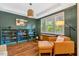 Stylish living room features hardwood floors, custom built-ins, a cozy chair, and ample natural light at 3650 Brooks Bnd, Franklinton, NC 27525