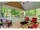Cozy screened-in porch with ample seating and serene views of the surrounding nature at 3650 Brooks Bnd, Franklinton, NC 27525