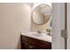 Well-lit powder room featuring a decorative mirror, marble countertop, and a modern vanity, offering convenience and style at 3650 Brooks Bnd, Franklinton, NC 27525