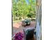 Backyard patio with table, chairs, and plants, next to a white home at 3838 Regent Rd, Durham, NC 27707