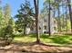 The backyard is perfect for outdoor activities with mature trees and plenty of space at 3838 Regent Rd, Durham, NC 27707