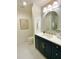 Stylish bathroom featuring a vanity with navy cabinets, quartz countertop, and modern fixtures, providing an elegant space at 3838 Regent Rd, Durham, NC 27707