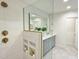 A modern bathroom with double vanity, decorative mirror, and tile shower at 3838 Regent Rd, Durham, NC 27707