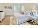 Well lit bedroom with large windows, hardwood floors, and stylish decor at 3838 Regent Rd, Durham, NC 27707