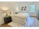 Cozy bedroom with a white comforter, area rug, and side table with lamps for a comfortable and inviting space at 3838 Regent Rd, Durham, NC 27707