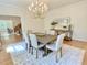 Formal dining room featuring a large table, chandelier, and stylish console table, exuding classic charm at 3838 Regent Rd, Durham, NC 27707