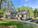 Attractive home with neutral colored brick, mature trees, landscaping and an attached two car garage at 3838 Regent Rd, Durham, NC 27707