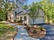 Elegant white home featuring a spacious three-car garage at 3838 Regent Rd, Durham, NC 27707