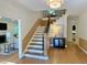 Beautiful foyer with hardwood floors, staircase, and elegant lighting at 3838 Regent Rd, Durham, NC 27707