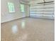Spacious two car garage with sealed floor, two windows and white garage door at 3838 Regent Rd, Durham, NC 27707
