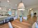 Open kitchen with modern pendant lighting, white cabinetry, and center island at 3838 Regent Rd, Durham, NC 27707