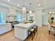 Bright kitchen with a large island, stainless steel appliances, and wood flooring at 3838 Regent Rd, Durham, NC 27707