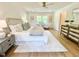 A spacious bedroom with hardwood floors, lots of natural light, and stylish decor at 3838 Regent Rd, Durham, NC 27707