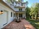 Charming brick patio with outdoor dining set and access to the home's entrance at 3838 Regent Rd, Durham, NC 27707