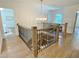 Beautiful staircase with wood floors, black metal railings, and chandelier at 3838 Regent Rd, Durham, NC 27707