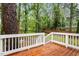 Back deck with wooden railings overlooks a large, lush backyard with mature trees at 3907 Inwood Dr, Durham, NC 27705