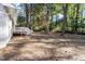 Large, private backyard surrounded by mature trees and featuring a small deck for relaxing and enjoying the outdoors at 3907 Inwood Dr, Durham, NC 27705
