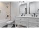Modern bathroom with double vanity, sleek fixtures, and a tiled shower-tub combination for a spa-like experience at 3907 Inwood Dr, Durham, NC 27705
