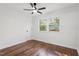 Bedroom with hardwood floors, natural light, and a modern ceiling fan fixture at 3907 Inwood Dr, Durham, NC 27705