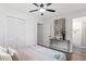 Cozy bedroom features hardwood floors, a ceiling fan, closet doors, and access to the en suite bathroom at 3907 Inwood Dr, Durham, NC 27705