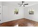 Bedroom with hardwood floors, a ceiling fan, and natural light from the windows at 3907 Inwood Dr, Durham, NC 27705