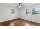 Sun-filled bedroom showcasing hardwood floors and double windows with backyard views at 3907 Inwood Dr, Durham, NC 27705