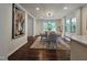 Bright dining room features a modern light fixture and large windows for natural lighting at 3907 Inwood Dr, Durham, NC 27705