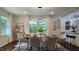 Elegant dining room with modern light fixture, large windows, and seating for six at 3907 Inwood Dr, Durham, NC 27705