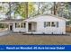 Charming single-story home featuring painted brick, modern fixtures, covered parking, and a well-maintained front yard at 3907 Inwood Dr, Durham, NC 27705