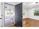 Exterior door leading into updated living room with hardwood floors and natural light at 3907 Inwood Dr, Durham, NC 27705