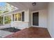 Inviting front entrance with a dark-colored door, brick accents, and a covered carport, providing curb appeal at 3907 Inwood Dr, Durham, NC 27705