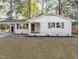 Charming brick home with black trim, covered carport, and well-manicured front yard at 3907 Inwood Dr, Durham, NC 27705