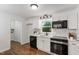 Bright kitchen with white cabinets, stainless steel appliances, and stylish fixtures at 3907 Inwood Dr, Durham, NC 27705
