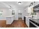 Open concept kitchen and dining area with stainless steel appliances and tile backsplash at 3907 Inwood Dr, Durham, NC 27705