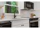 Bright kitchen features white cabinets, subway tile backsplash, modern appliances, and a stainless steel range at 3907 Inwood Dr, Durham, NC 27705